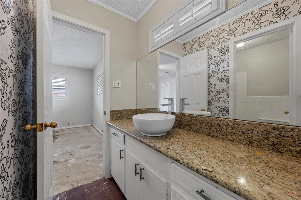 849 Deer Ridge Drive Woodway, TX 76712 - Photo 14 of 25 a bathroom with a granite countertop sink and a mirror