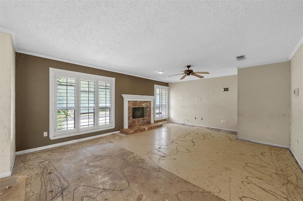 849 Deer Ridge Drive Woodway, TX 76712 - Photo 3 of 25 an empty room with windows fireplace and windows