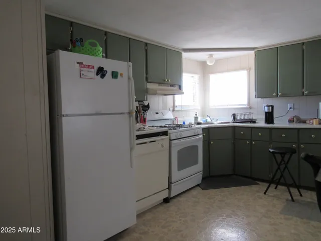 a white refrigerator freezer sitting in a kitchen