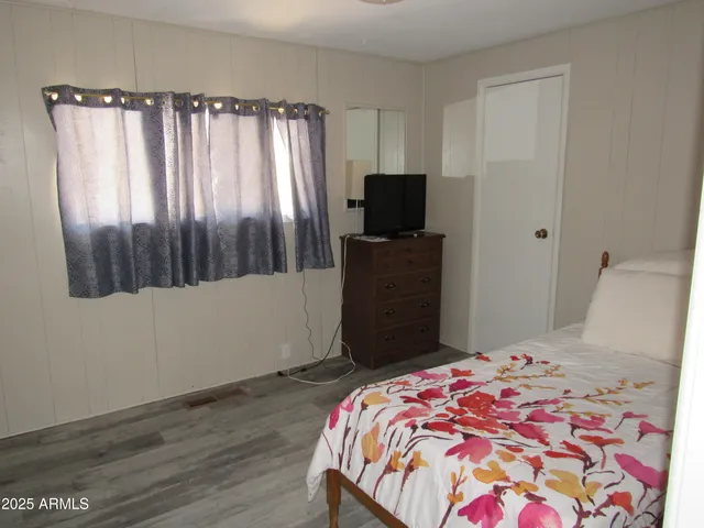 a bedroom with a bed and a television