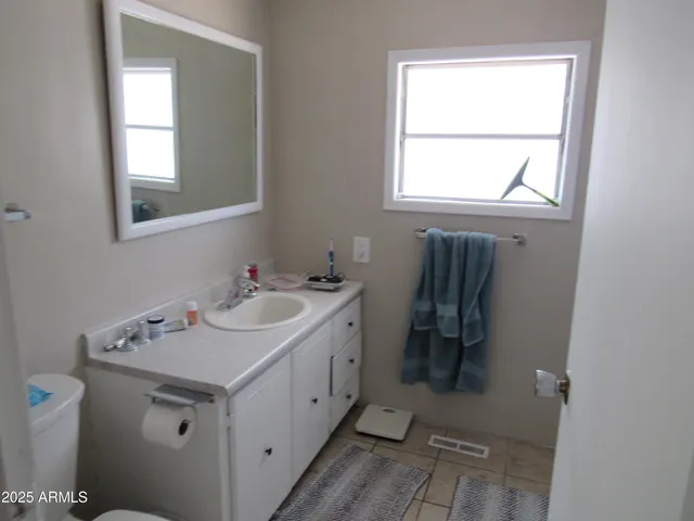 a bathroom with a sink toilet and mirror