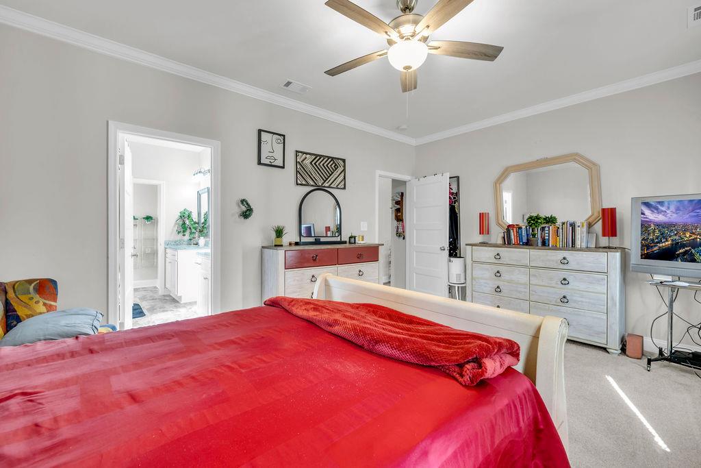 814 Natures Walk Gray, GA 31032 - Photo 11 of 27 a bedroom with a large bed and a chandelier