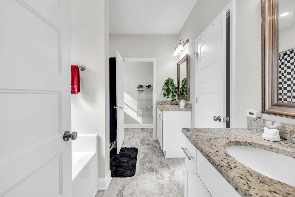 814 Natures Walk Gray, GA 31032 - Photo 12 of 27 a bathroom with a granite countertop sink and a mirror