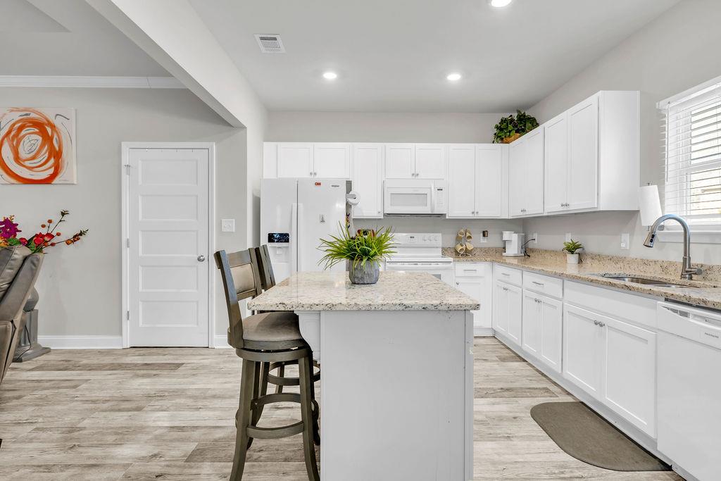 814 Natures Walk Gray, GA 31032 - Photo 16 of 27 a kitchen with granite countertop white cabinets and chairs