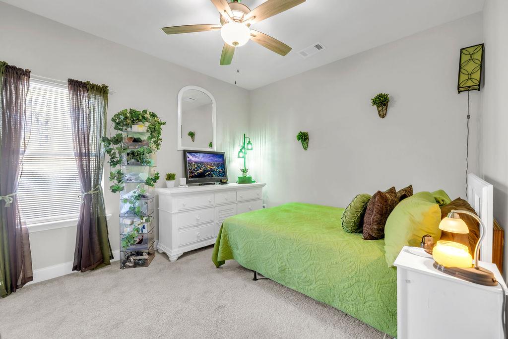 814 Natures Walk Gray, GA 31032 - Photo 5 of 27 a bedroom with a bed and ceiling fan