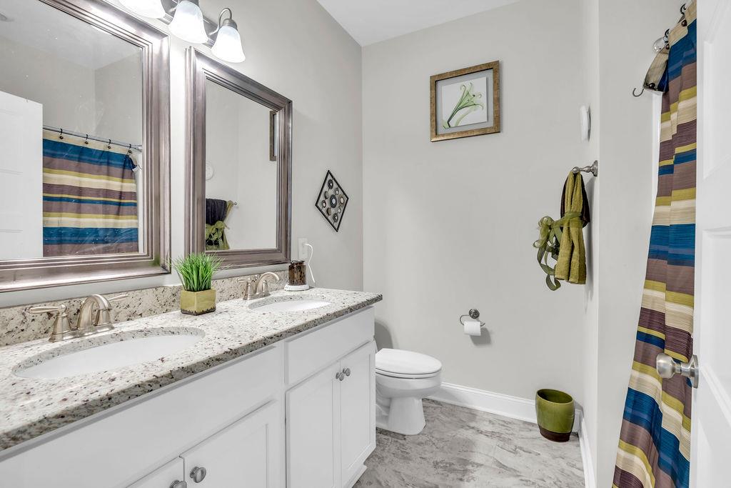 814 Natures Walk Gray, GA 31032 - Photo 6 of 27 a bathroom with a granite countertop sink and a mirror