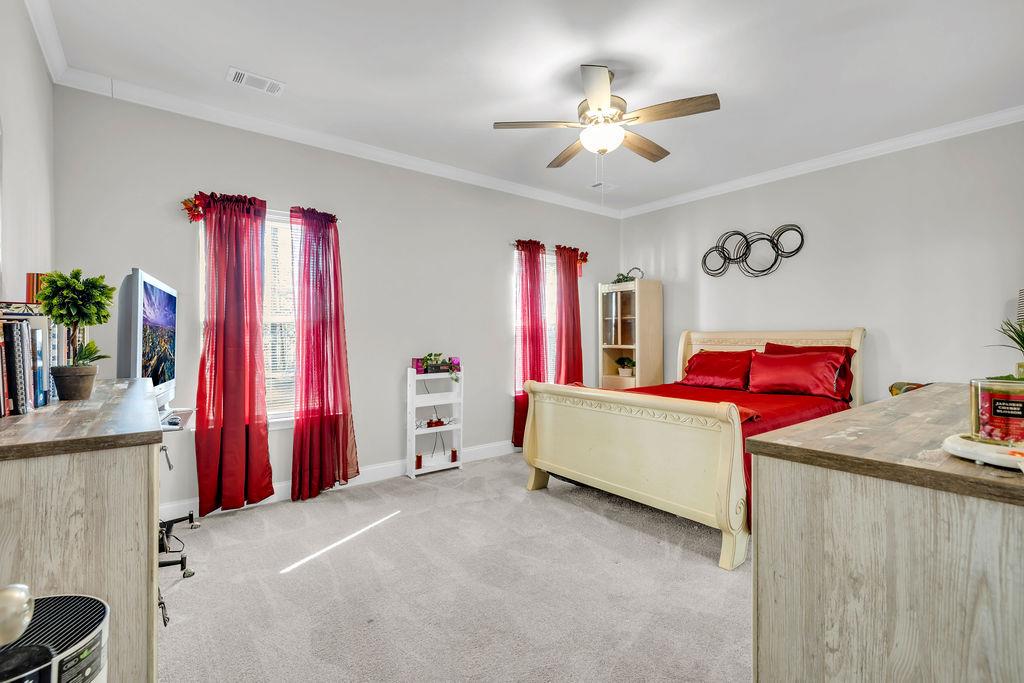 814 Natures Walk Gray, GA 31032 - Photo 8 of 27 a bed room with a bed and a chandelier