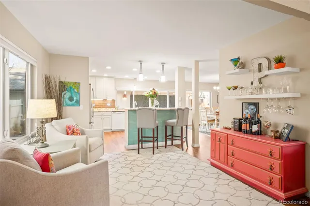 a living room with furniture and a kitchen area