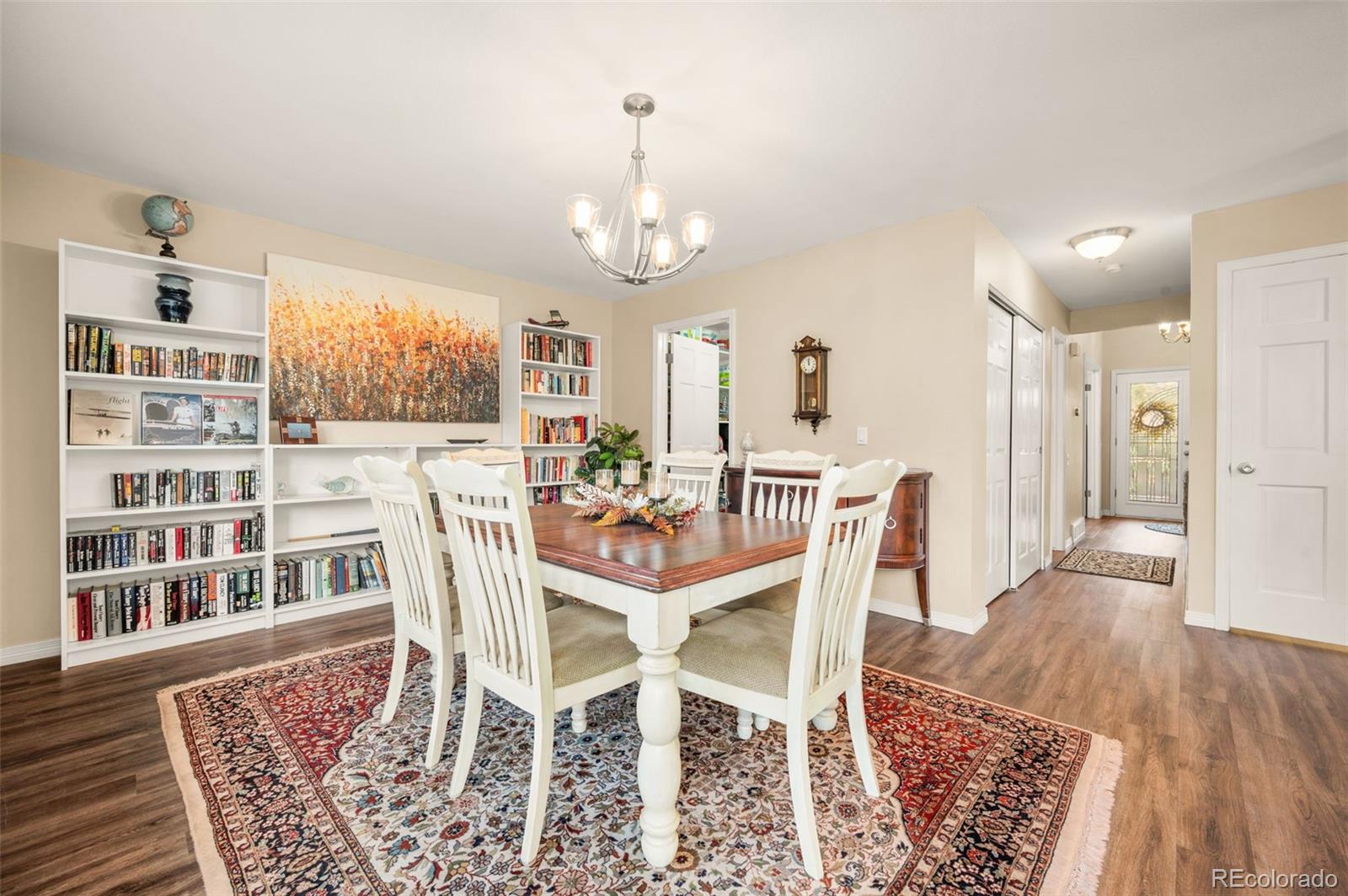 8734 Independence Way Arvada, CO 80005 - Photo 13 of 50 a view of a dining room with furniture and wooden floor