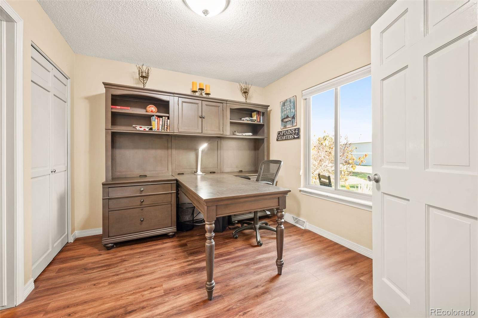 8734 Independence Way Arvada, CO 80005 - Photo 16 of 50 a room with furniture and wooden floor