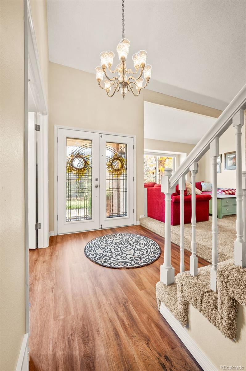 8734 Independence Way Arvada, CO 80005 - Photo 19 of 50 a view of a bedroom with wooden floor and windows