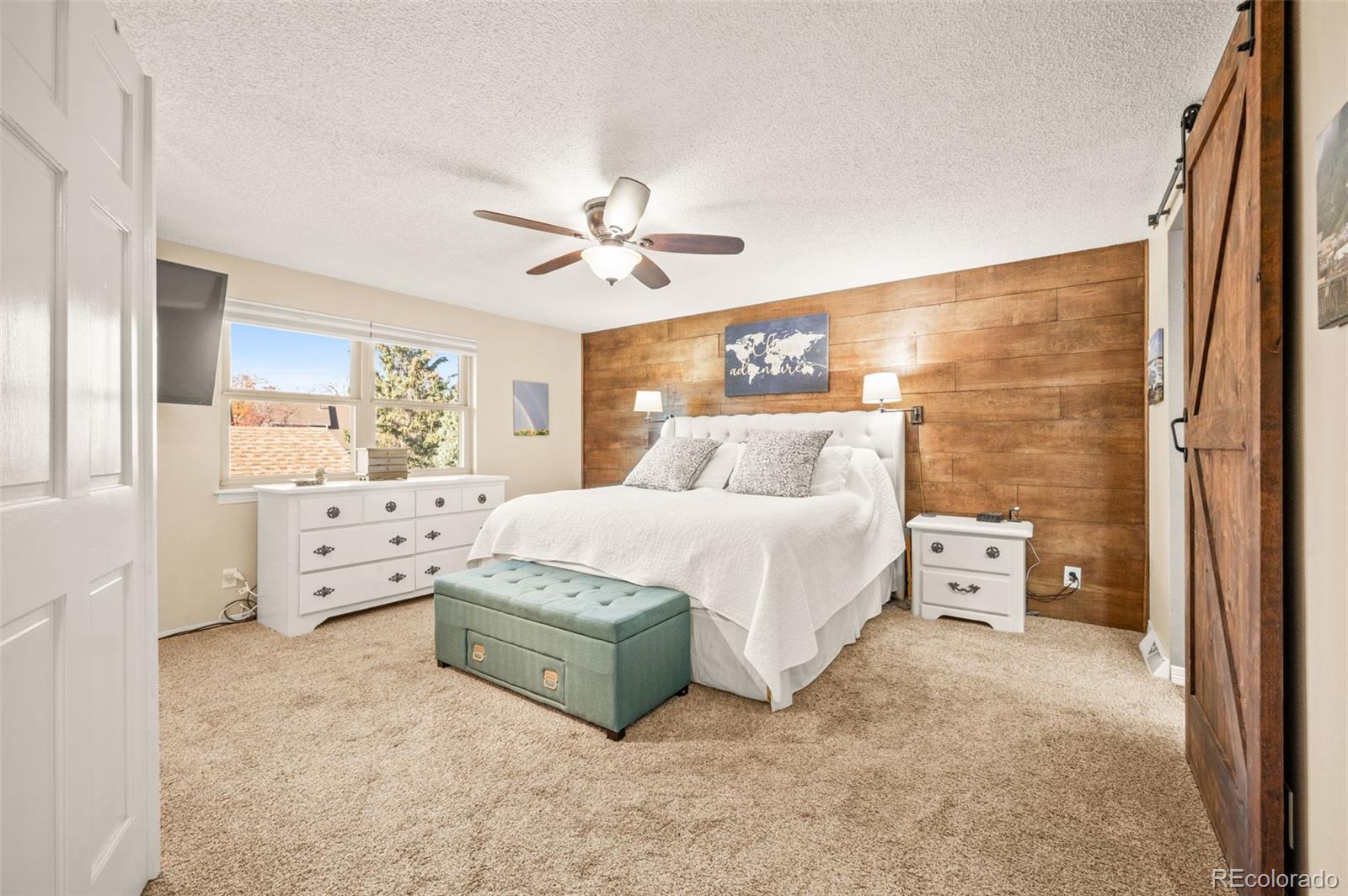 8734 Independence Way Arvada, CO 80005 - Photo 20 of 50 a spacious bedroom with a bed and a window
