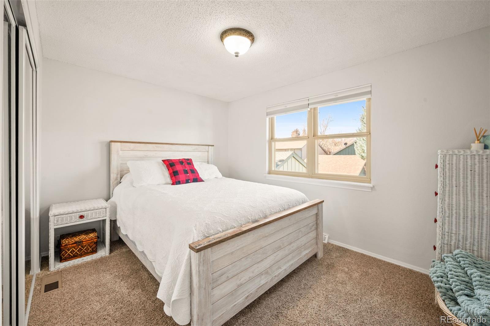8734 Independence Way Arvada, CO 80005 - Photo 23 of 50 a bed sitting in a bedroom next to a window