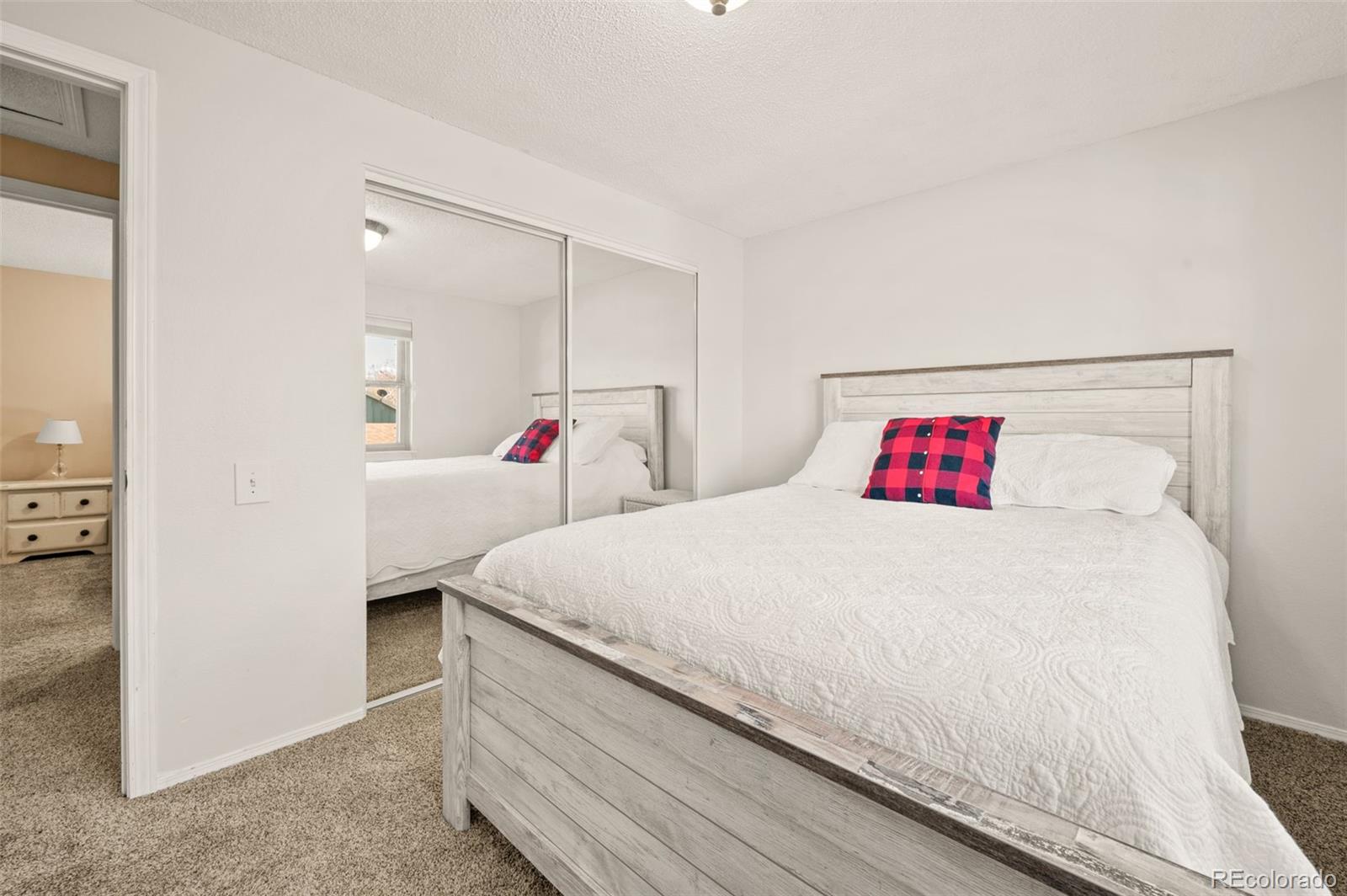 8734 Independence Way Arvada, CO 80005 - Photo 24 of 50 a bed room with a bed and a white kitchen
