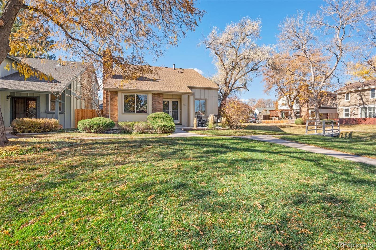 8734 Independence Way Arvada, CO 80005 - Photo 43 of 50 a front view of a house with a garden