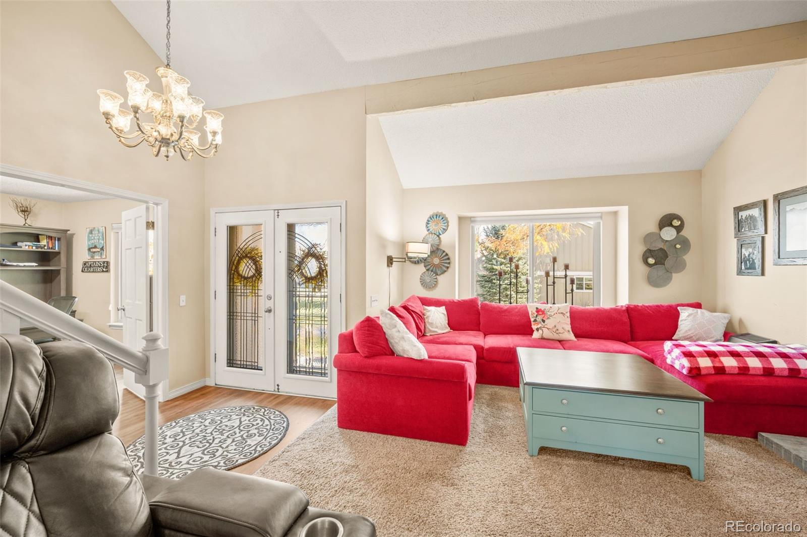 8734 Independence Way Arvada, CO 80005 - Photo 6 of 50 a living room with furniture and a large mirror
