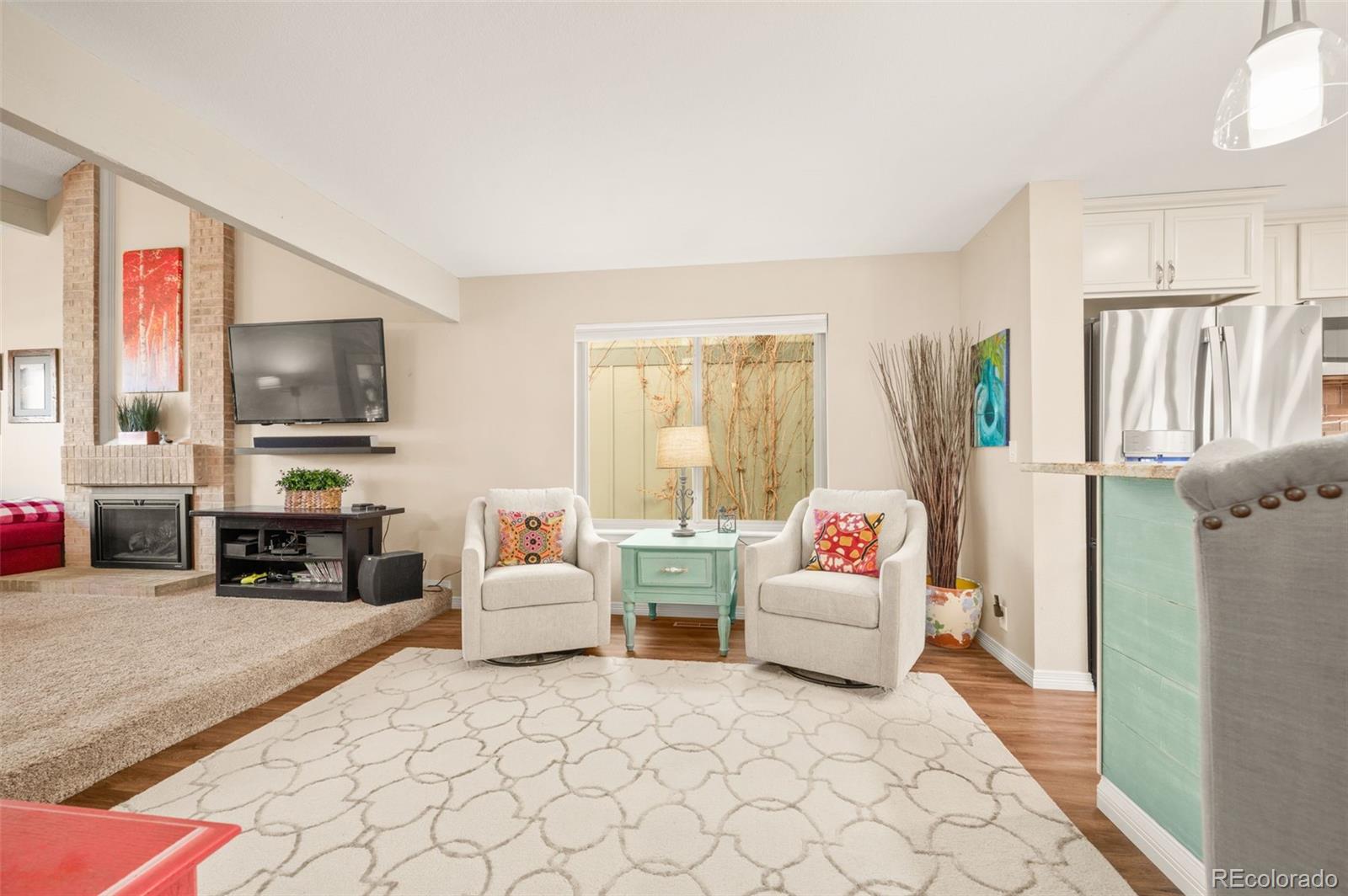 8734 Independence Way Arvada, CO 80005 - Photo 7 of 50 a living room with furniture and a flat screen tv