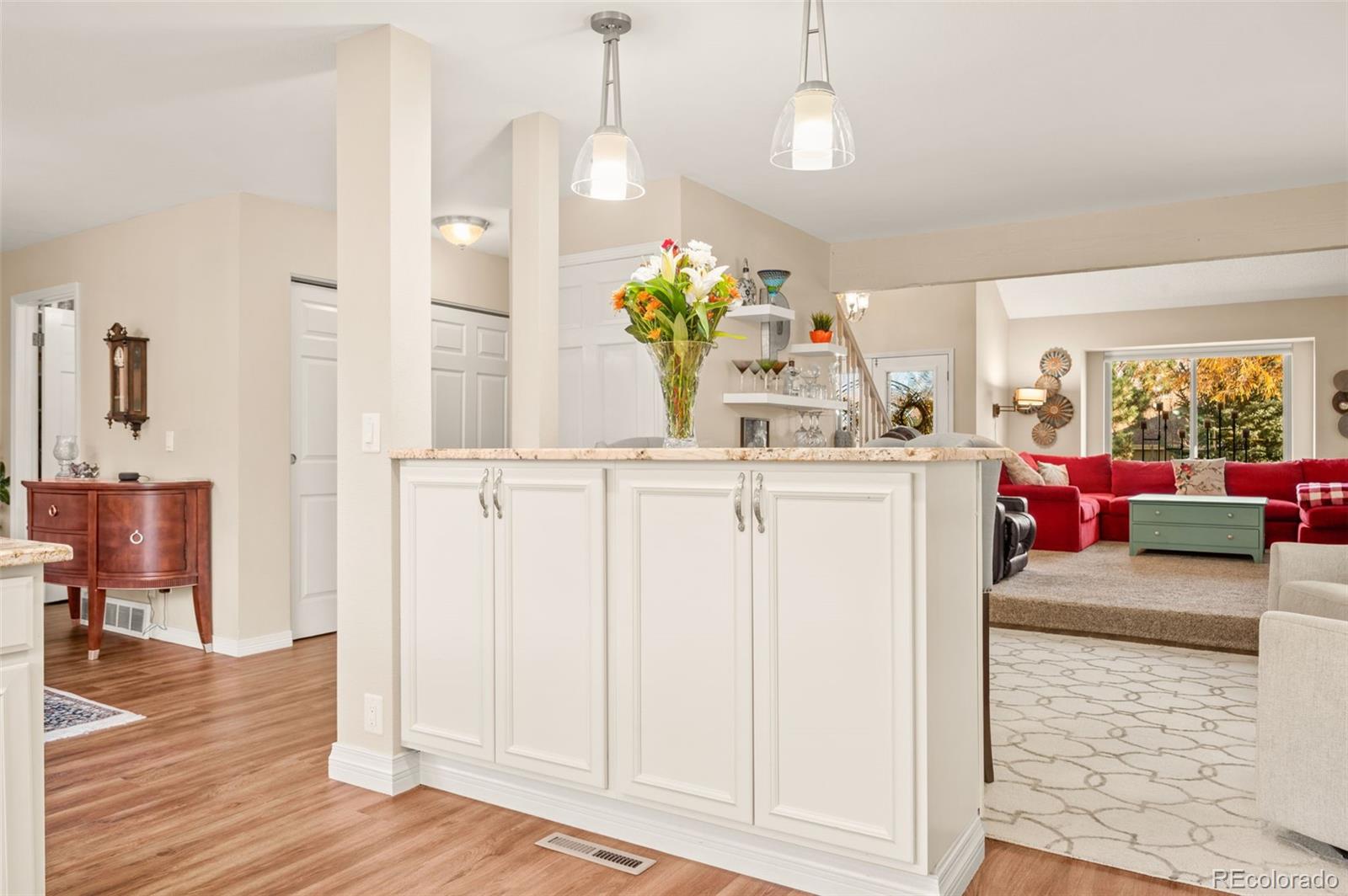 8734 Independence Way Arvada, CO 80005 - Photo 8 of 50 a living room with kitchen island furniture and a chandelier