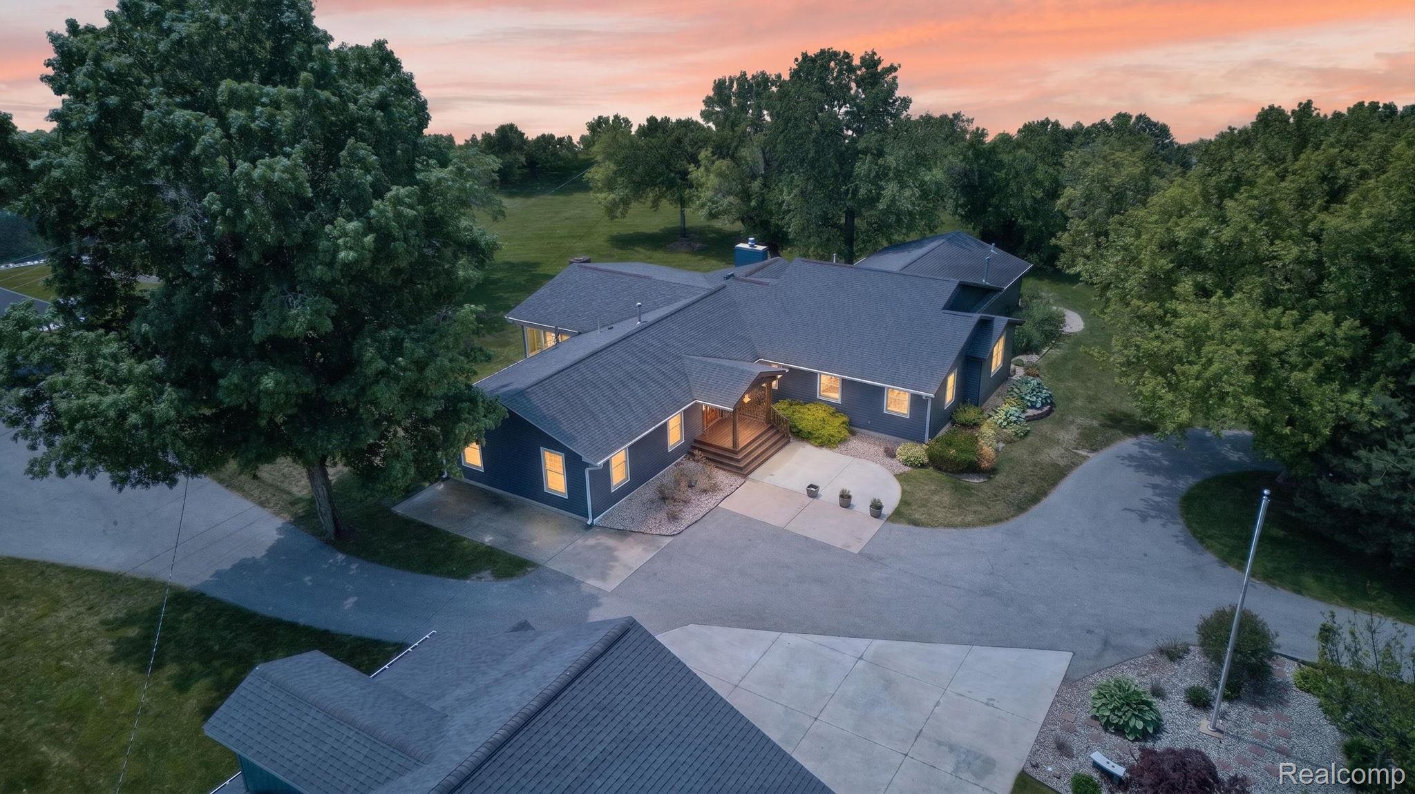 9353 Hill Road Swartz Creek, MI 48473 - Photo 1 of 98 Sprawling single-story residence with a dark gray shingle roof and blue exterior siding