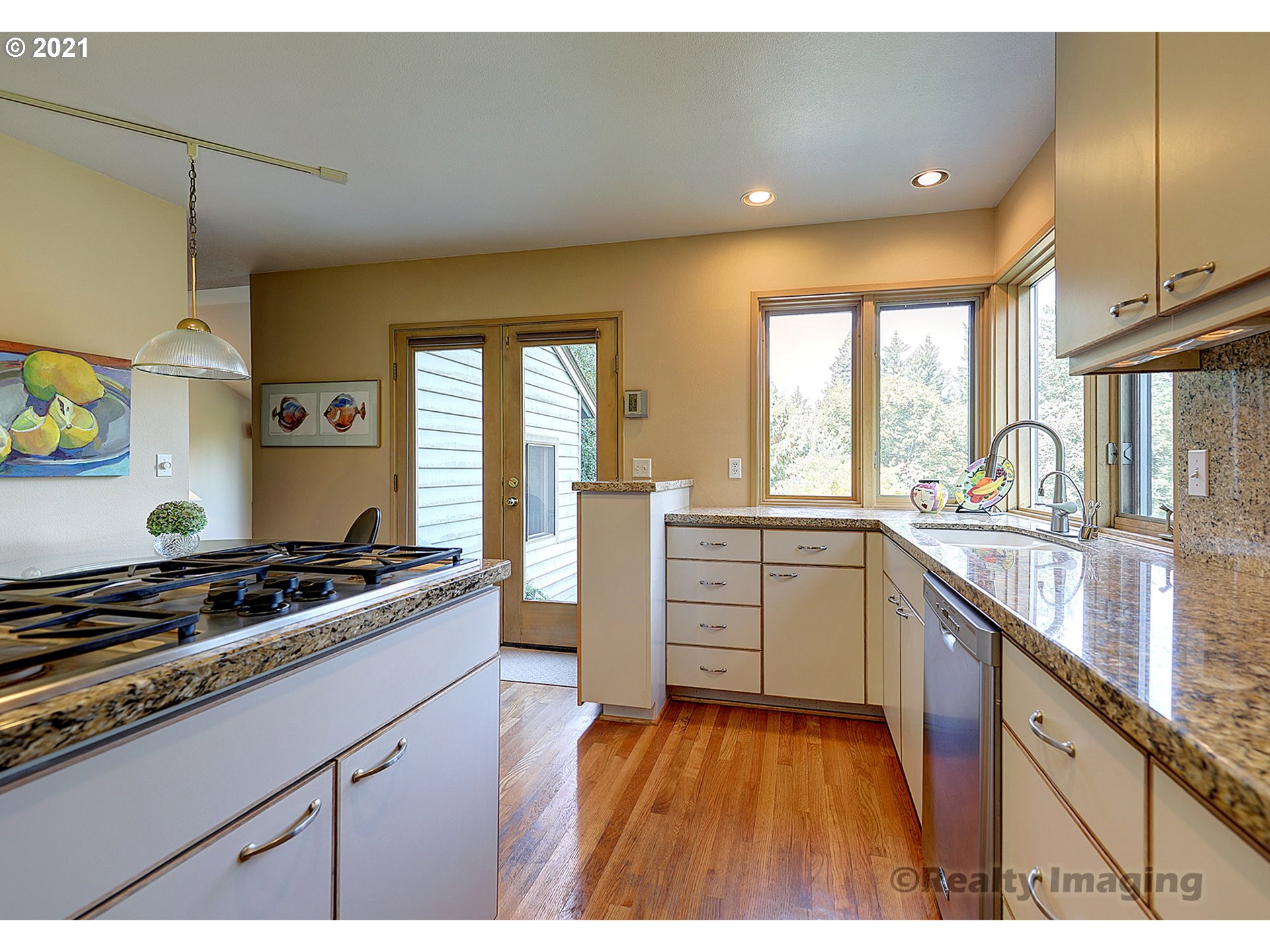 7402 Northwest Penridge Road Portland, OR 97229 - Photo 11 of 32 a kitchen with a stove a sink and a refrigerator