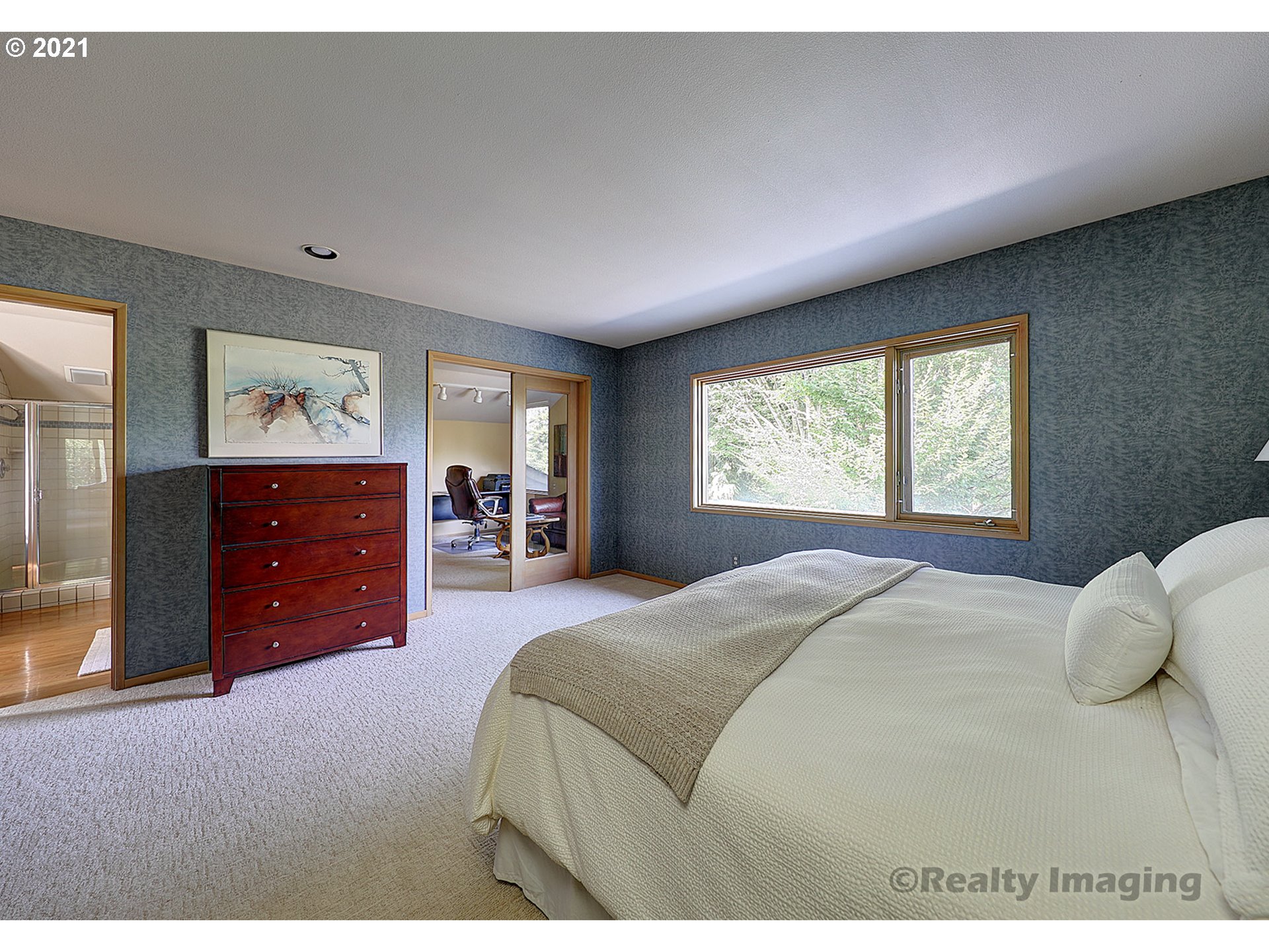 7402 Northwest Penridge Road Portland, OR 97229 - Photo 13 of 32 a bedroom with a bed and a dresser