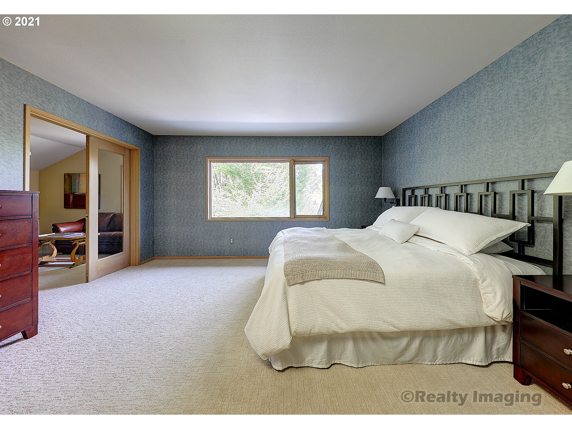 7402 Northwest Penridge Road Portland, OR 97229 - Photo 14 of 32 a bedroom with a bed and a large window