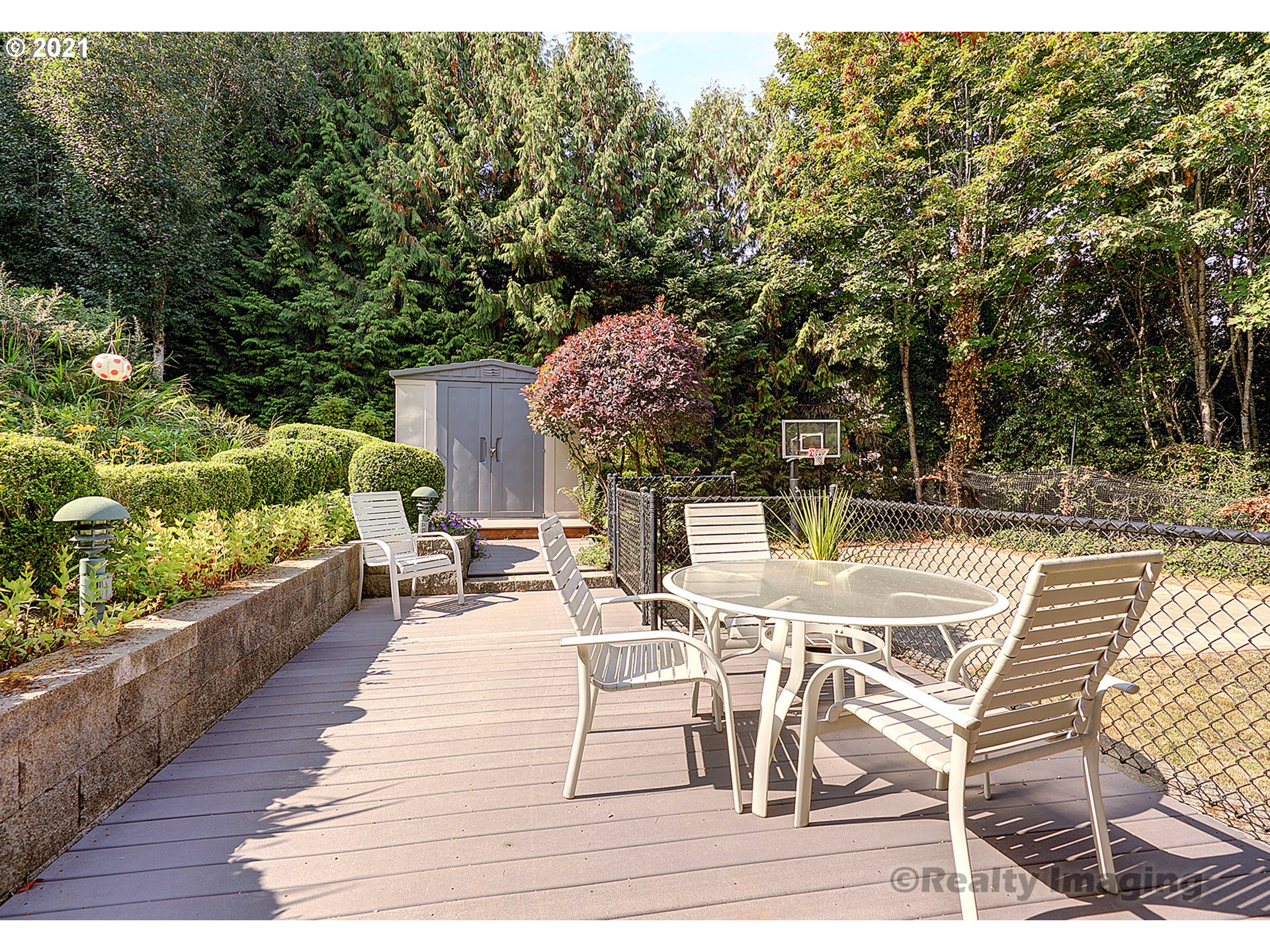 7402 Northwest Penridge Road Portland, OR 97229 - Photo 26 of 32 a view of a patio with table and chairs potted plants with wooden floor