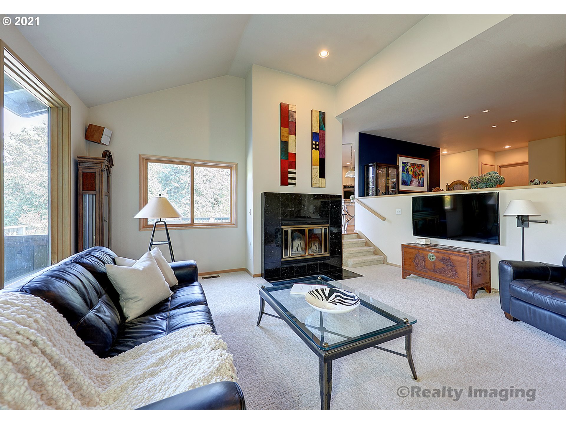 7402 Northwest Penridge Road Portland, OR 97229 - Photo 5 of 32 a living room with furniture a flat screen tv and a fireplace