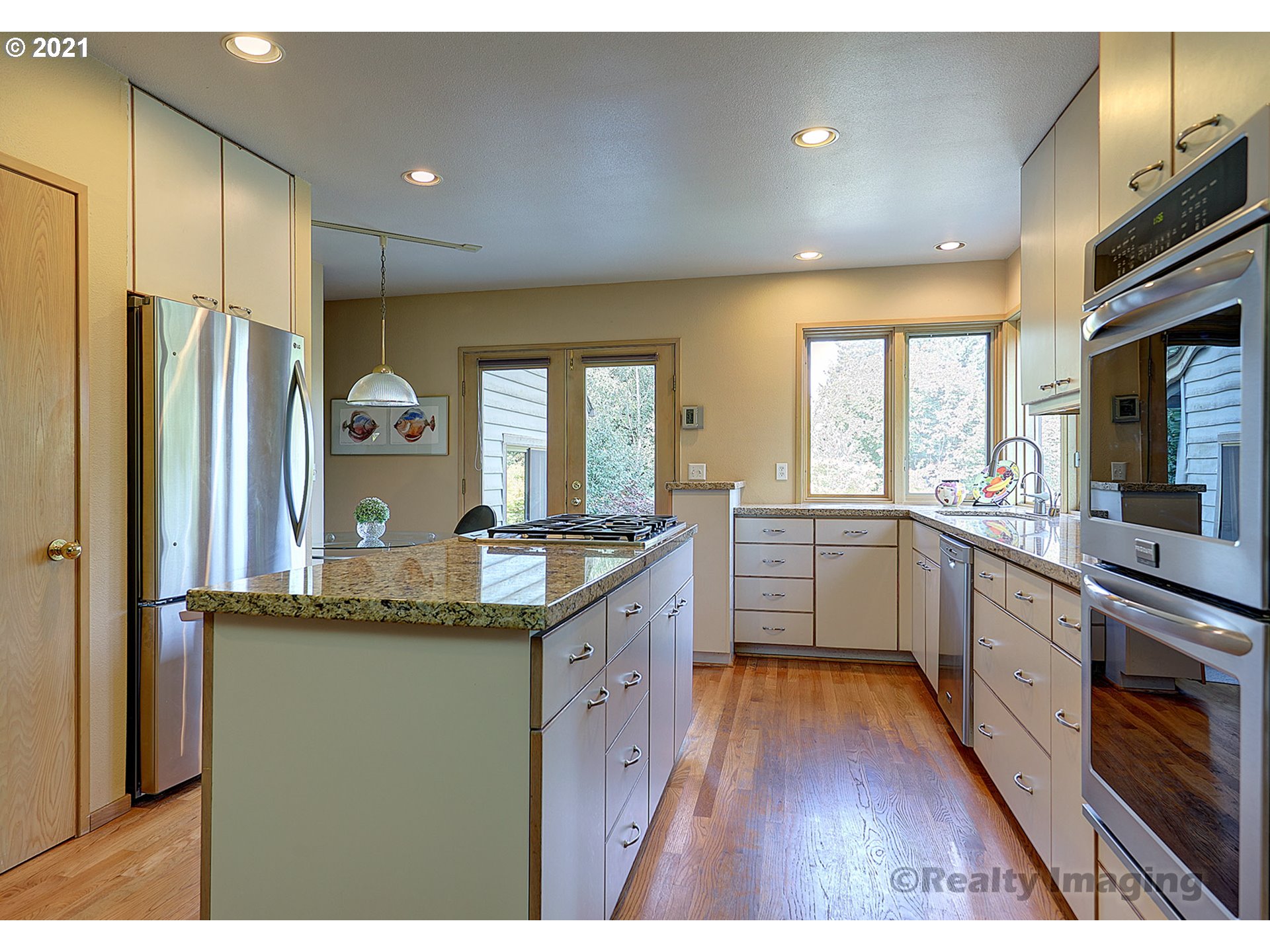 7402 Northwest Penridge Road Portland, OR 97229 - Photo 9 of 32 a kitchen with stainless steel appliances granite countertop a sink a stove and refrigerator