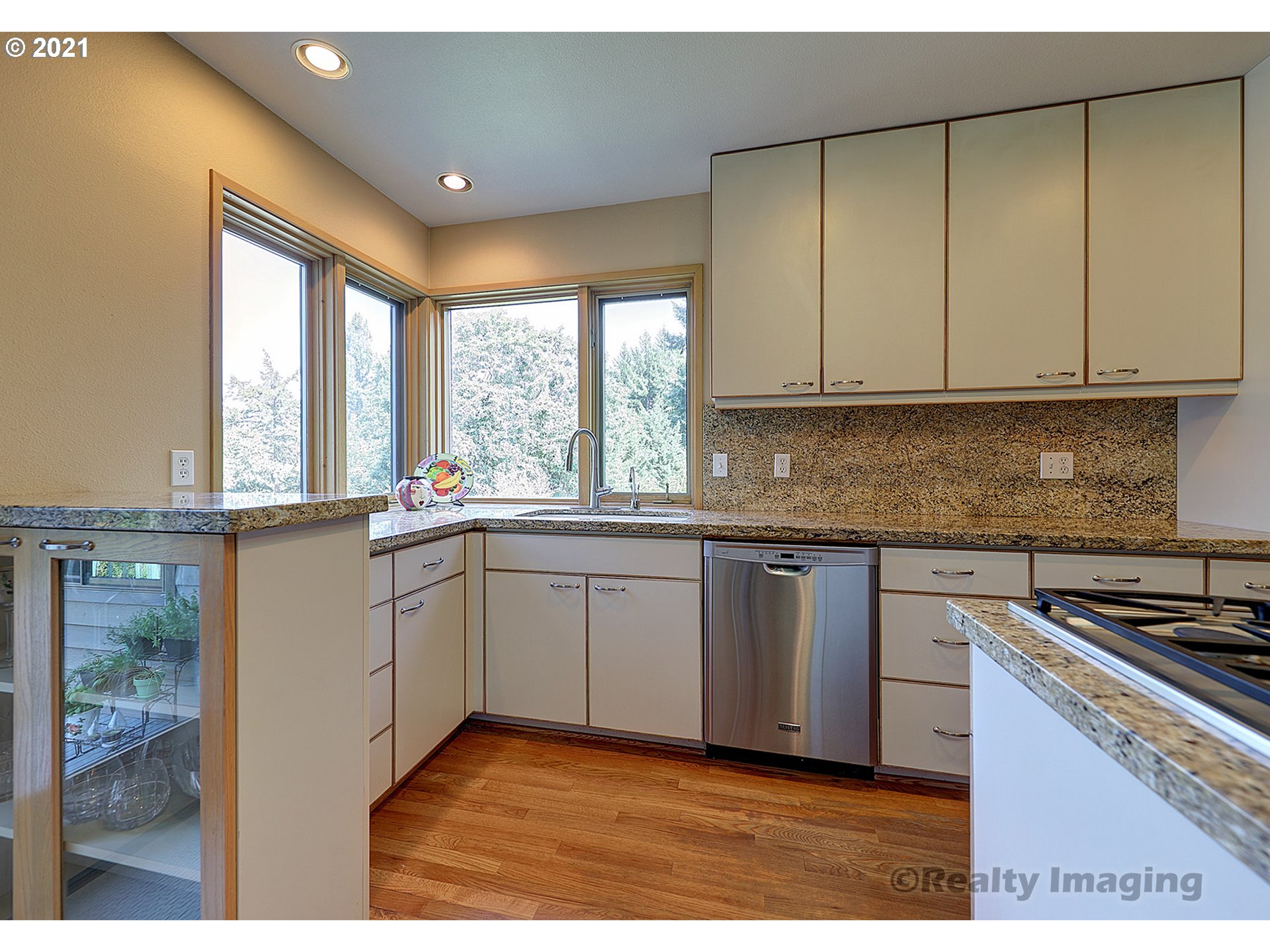 7402 Northwest Penridge Road Portland, OR 97229 - Photo 10 of 32 a kitchen with a sink window and cabinets