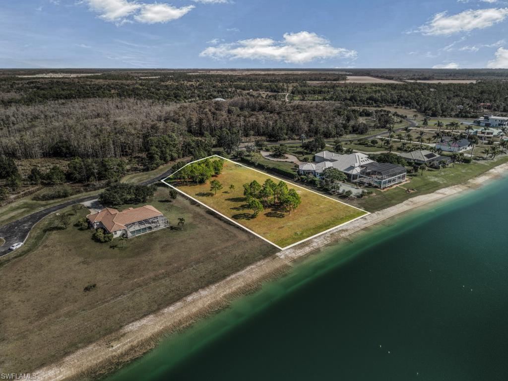 20200 Slalom Course Court Estero, FL 33928 - Photo 13 of 20 a view of a lake with a yard
