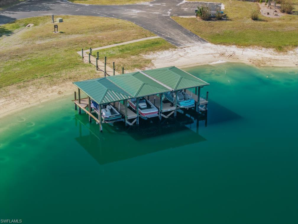 20200 Slalom Course Court Estero, FL 33928 - Photo 15 of 20 a view of a swimming pool with lawn chairs under an umbrella