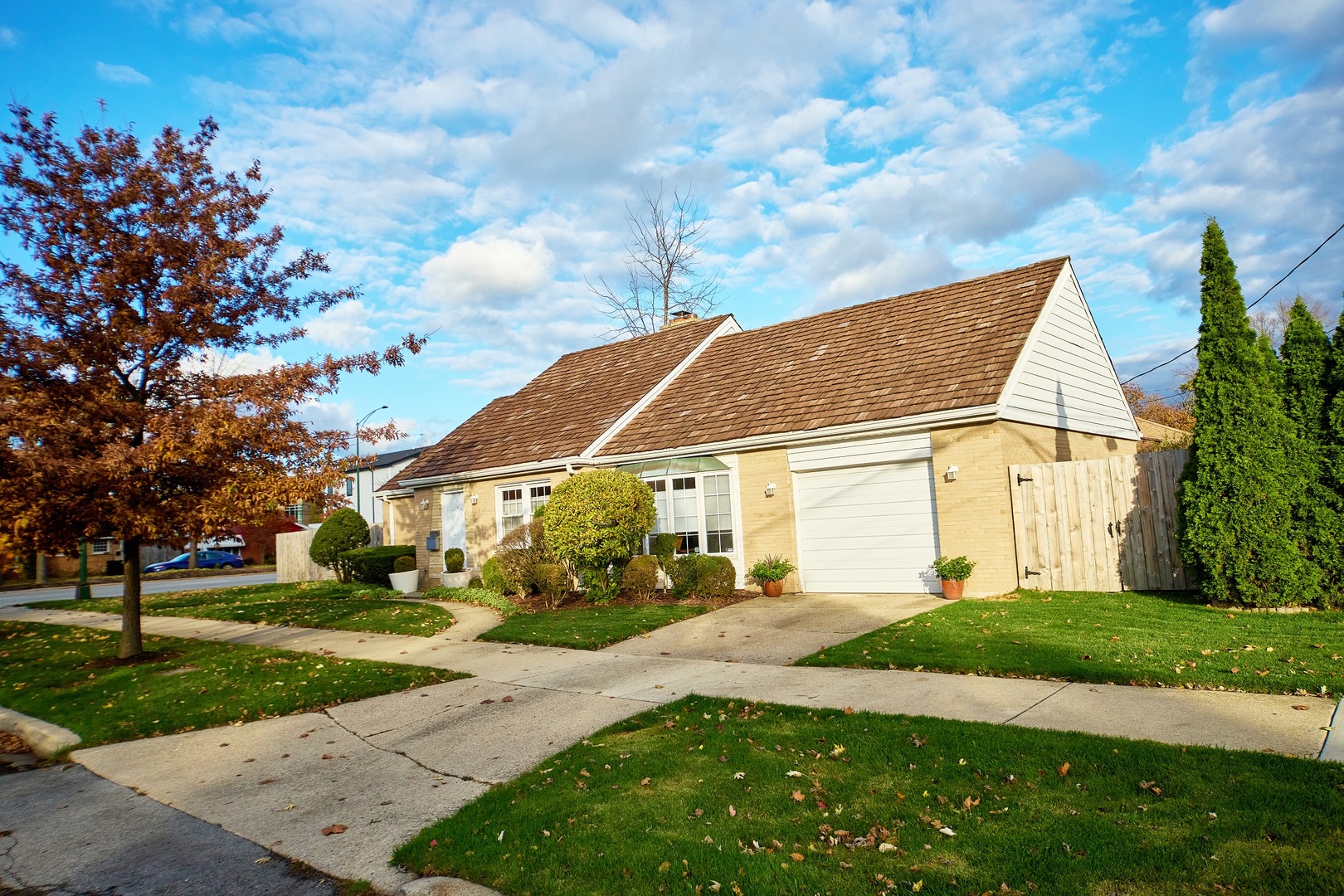 5955 North Keating Avenue Chicago, IL 60646 - Photo 22 of 22 a view of a white house next to a yard with big trees