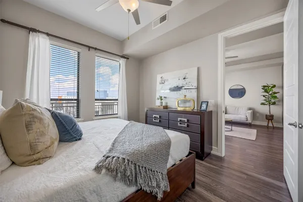 a bedroom with a bed and wooden floor
