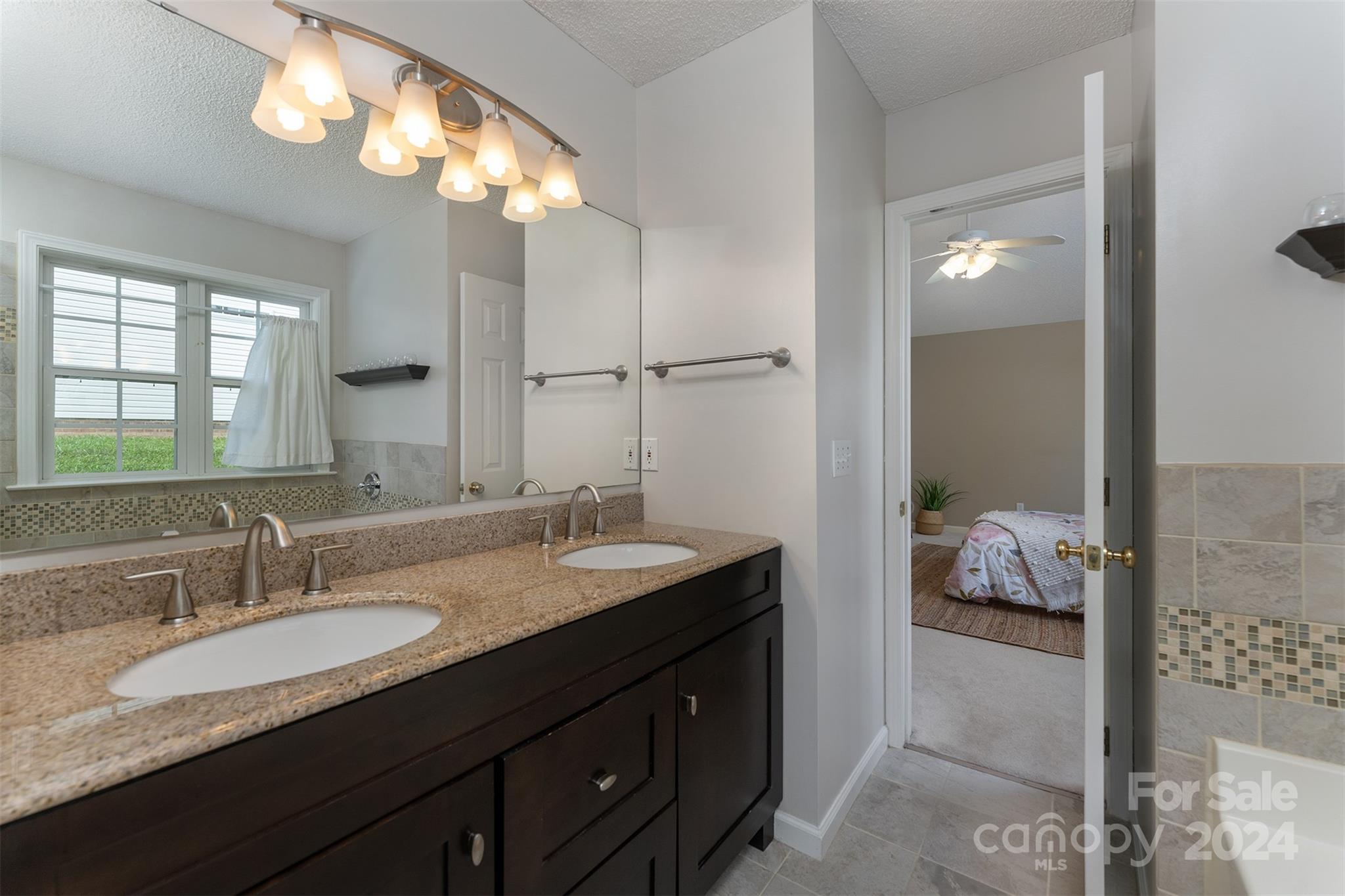 311 Planters Creek Road Fletcher, NC 28732 - Photo 13 of 24 a en suite bathroom with a granite countertop sink and a mirror