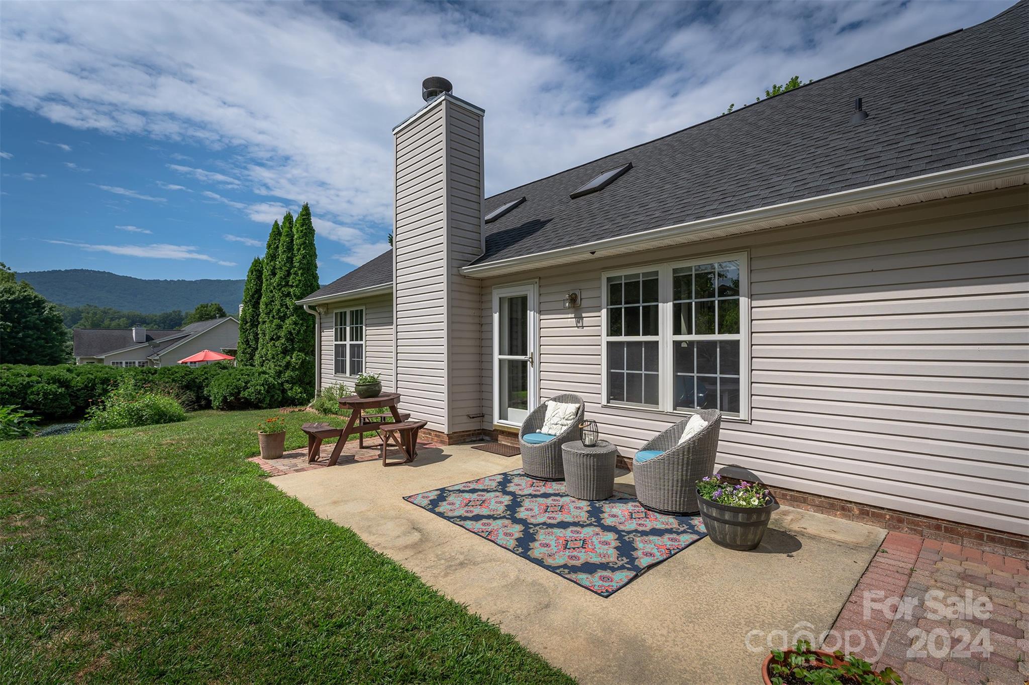 311 Planters Creek Road Fletcher, NC 28732 - Photo 20 of 24 a view of a patio with table and chairs and potted plants