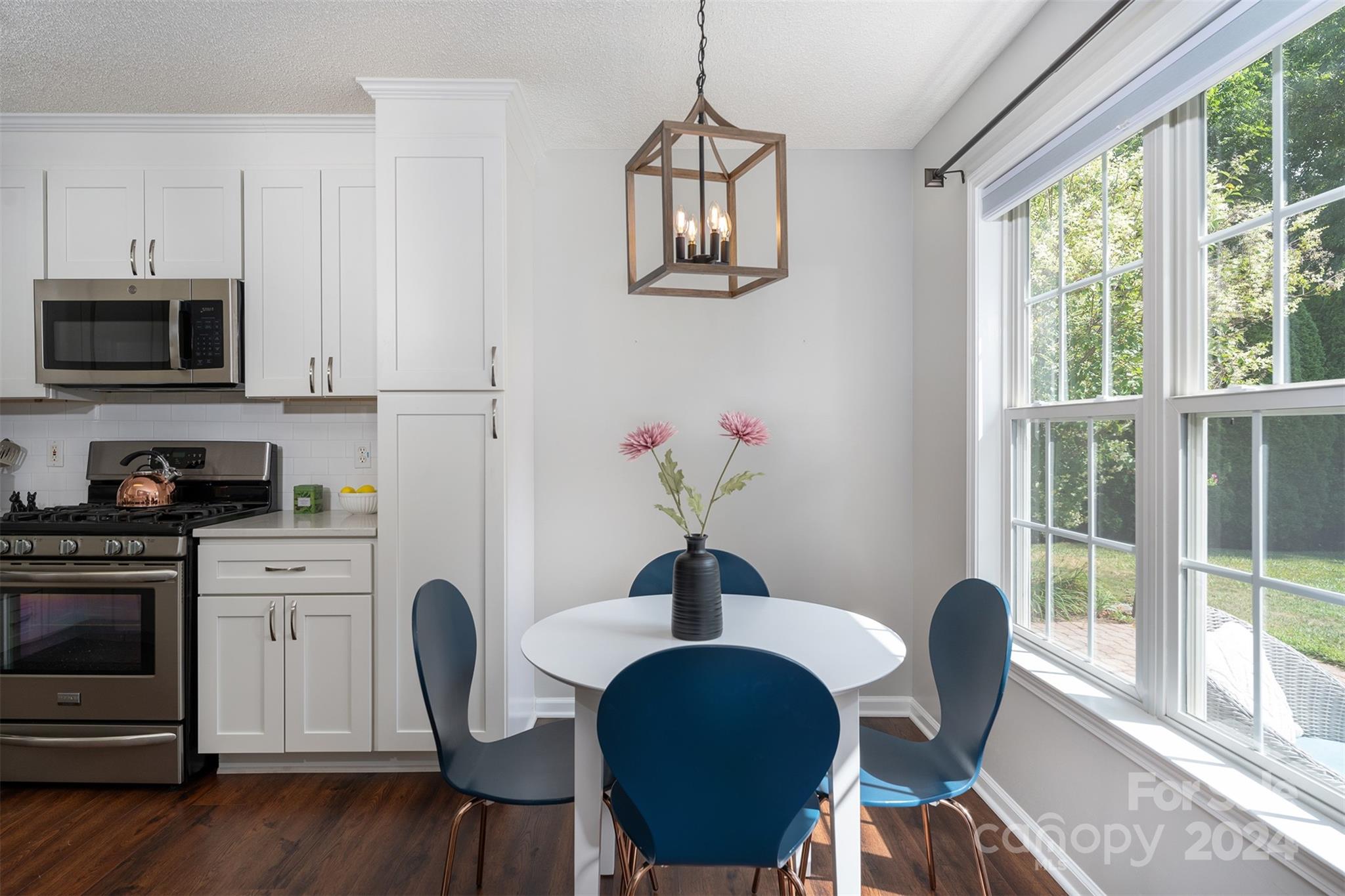 311 Planters Creek Road Fletcher, NC 28732 - Photo 8 of 24 a view of a dining room with furniture window and wooden floor
