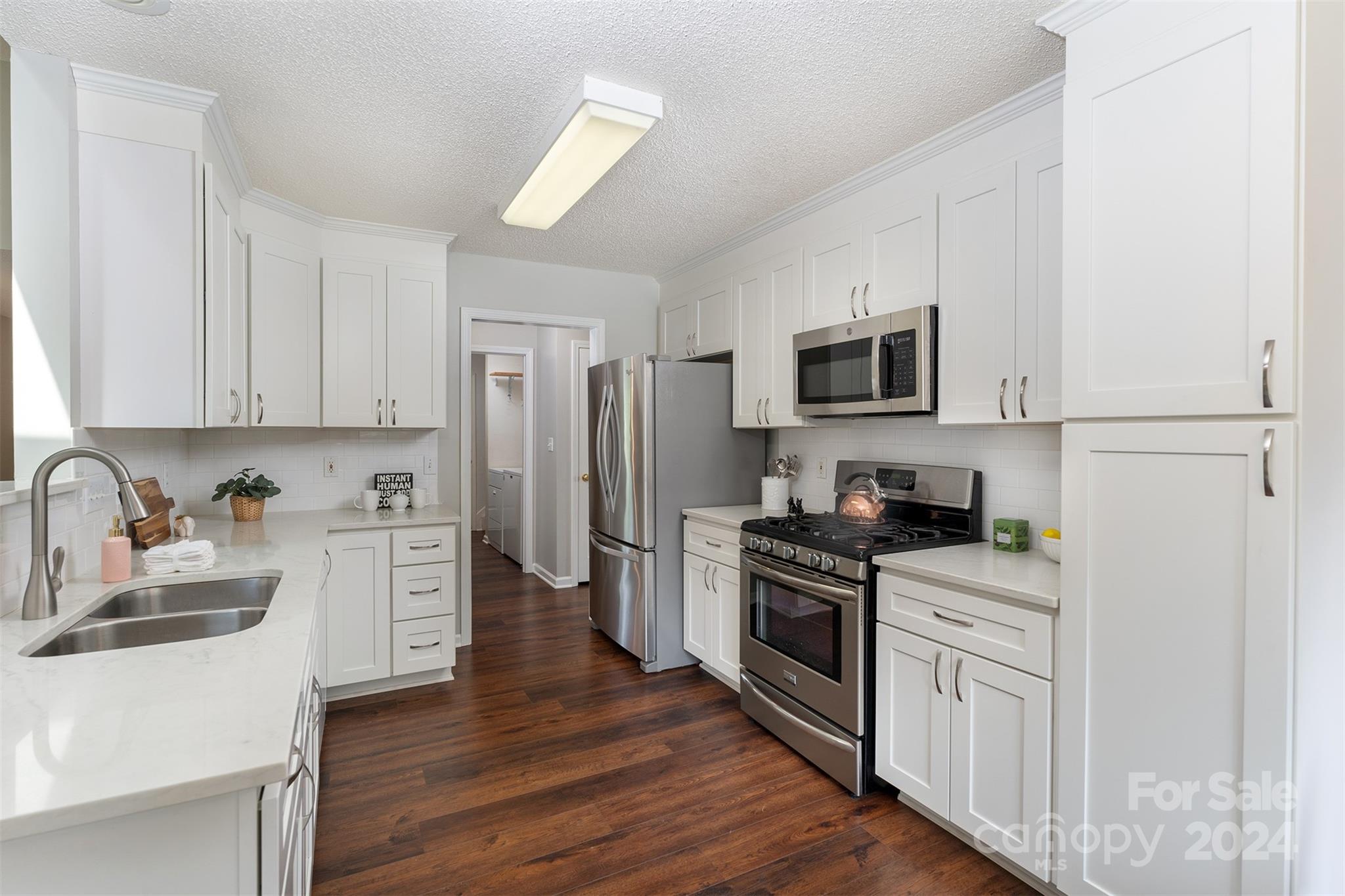 311 Planters Creek Road Fletcher, NC 28732 - Photo 9 of 24 a kitchen with stainless steel appliances a refrigerator stove and sink