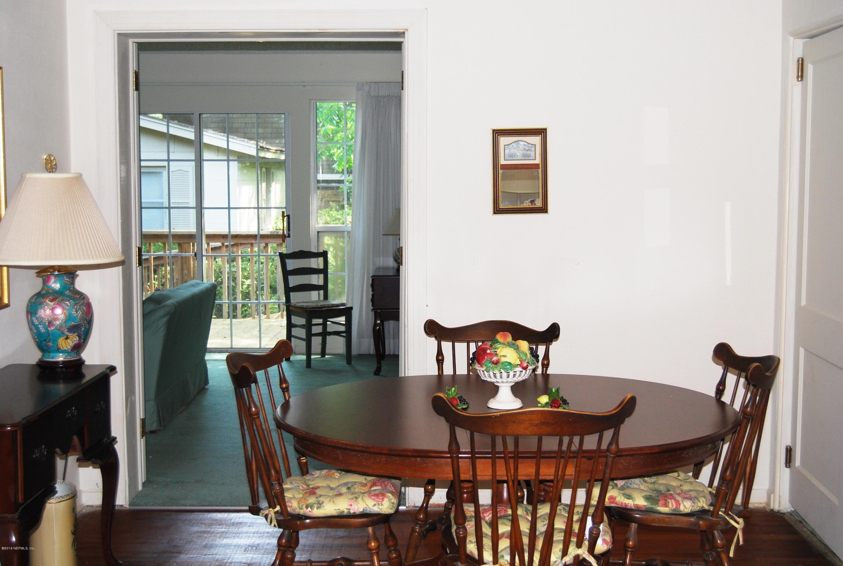 4411 Milstead Road Jacksonville, FL 32210 - Photo 8 of 31 a view of a dining room with furniture window and wooden floor