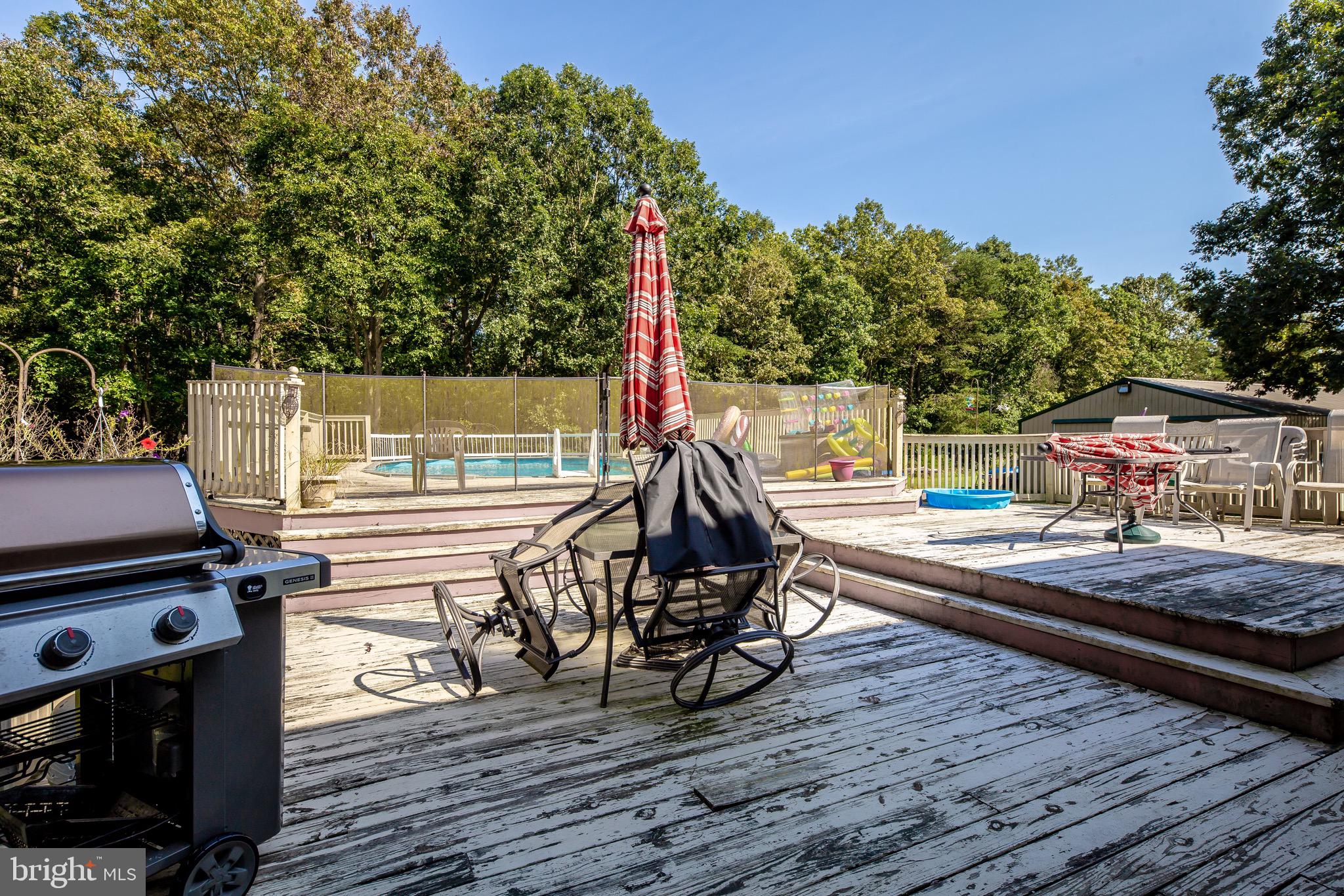 300 Ramah Road Bridgeton, NJ 08302 - Photo 23 of 41 a view of a roof deck with table and chairs a barbeque with wooden floor and fence