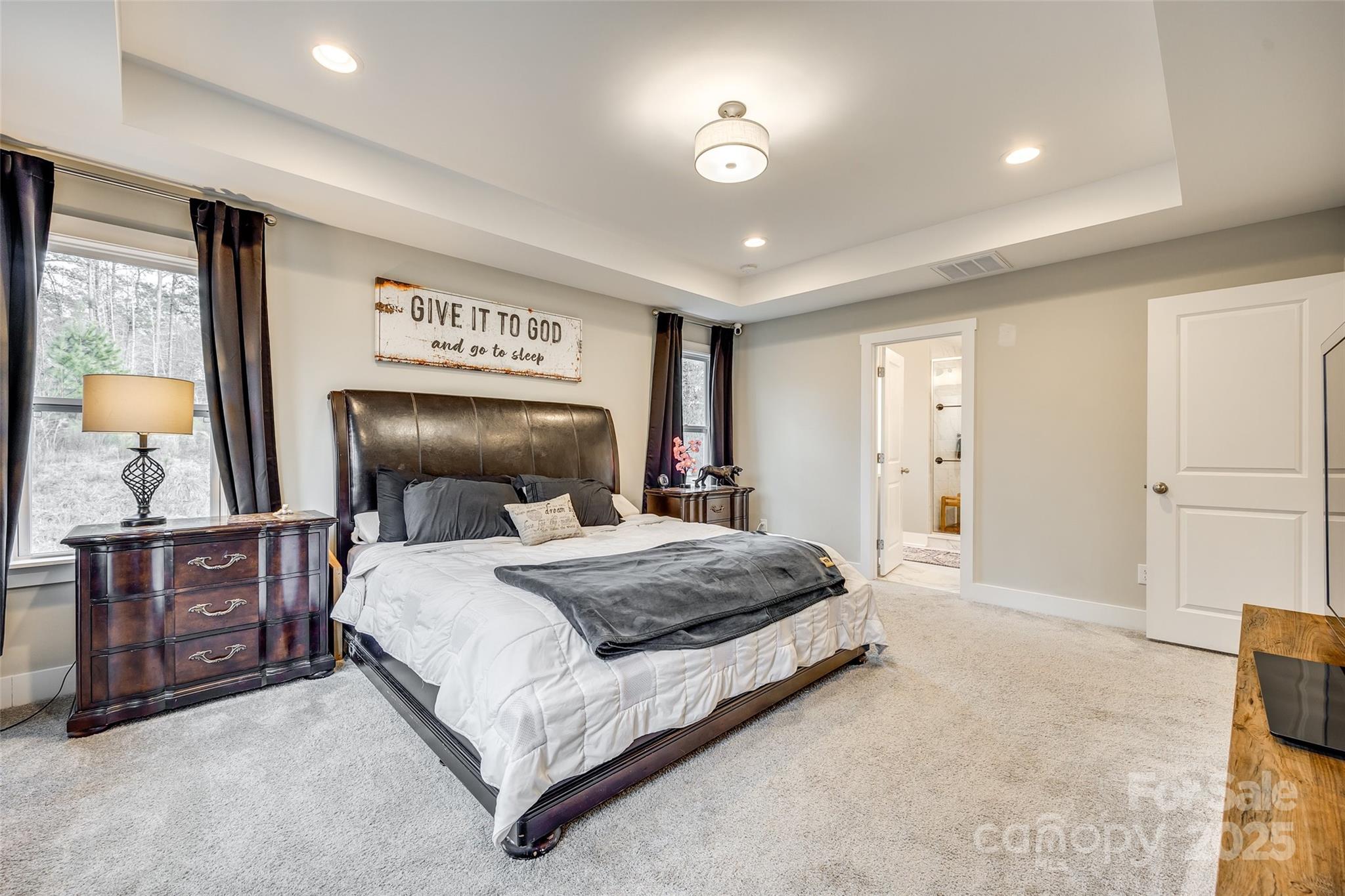 2024 Suttonview Road Fort Mill, SC 29708 - Photo 17 of 41 a bedroom with a large bed and a chandelier