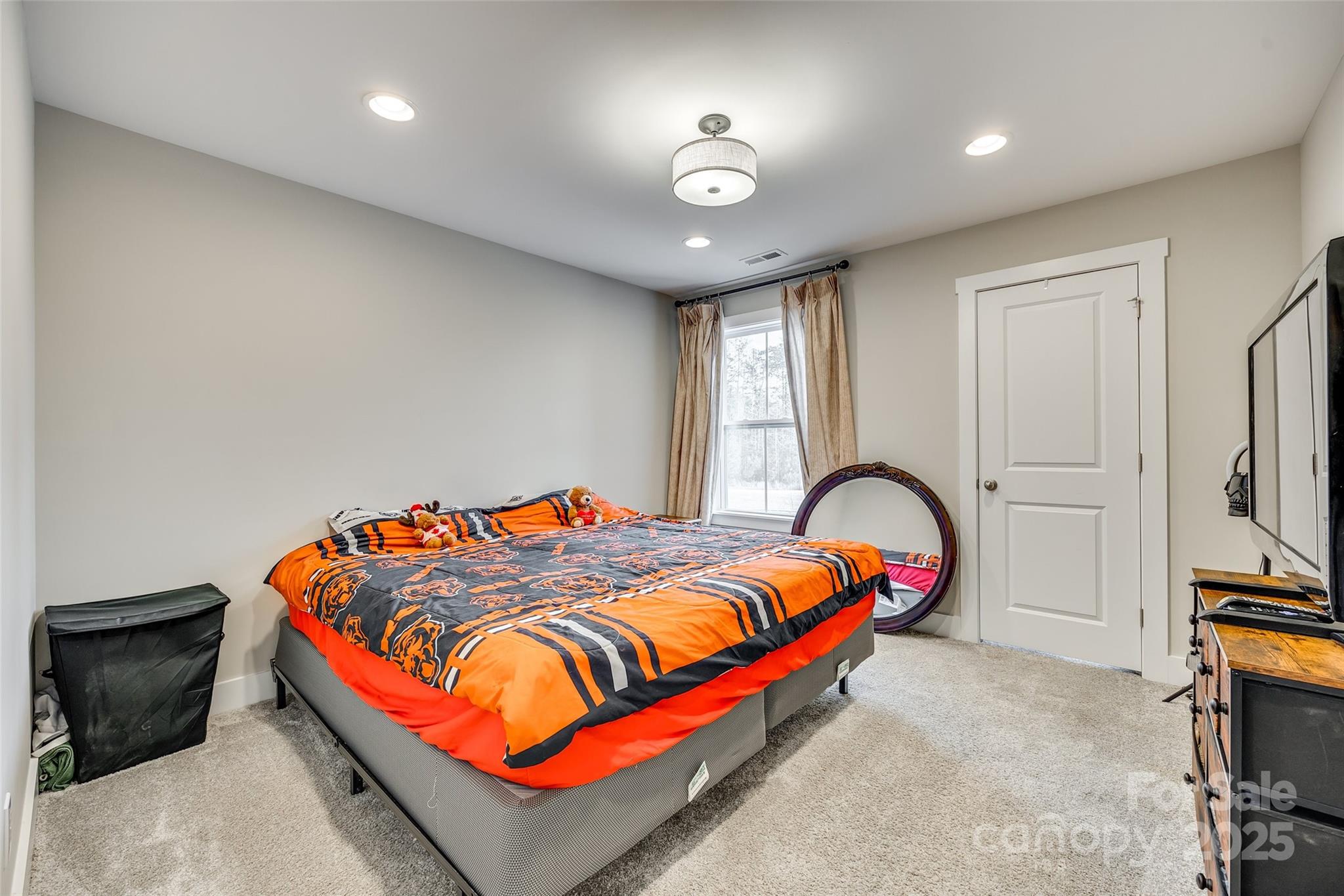 2024 Suttonview Road Fort Mill, SC 29708 - Photo 22 of 41 a bedroom with bed and a chandelier