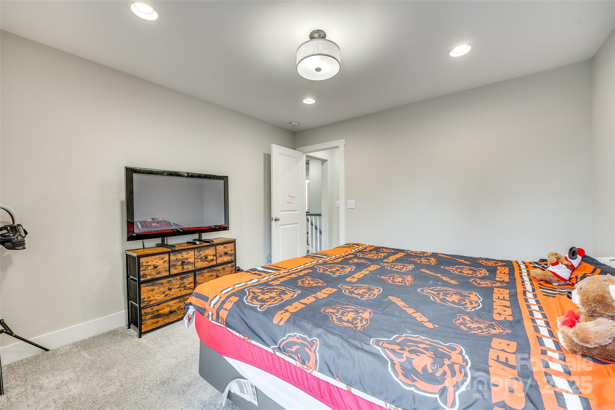 2024 Suttonview Road Fort Mill, SC 29708 - Photo 23 of 41 a bedroom with a bed and a flat tv screen on dresser