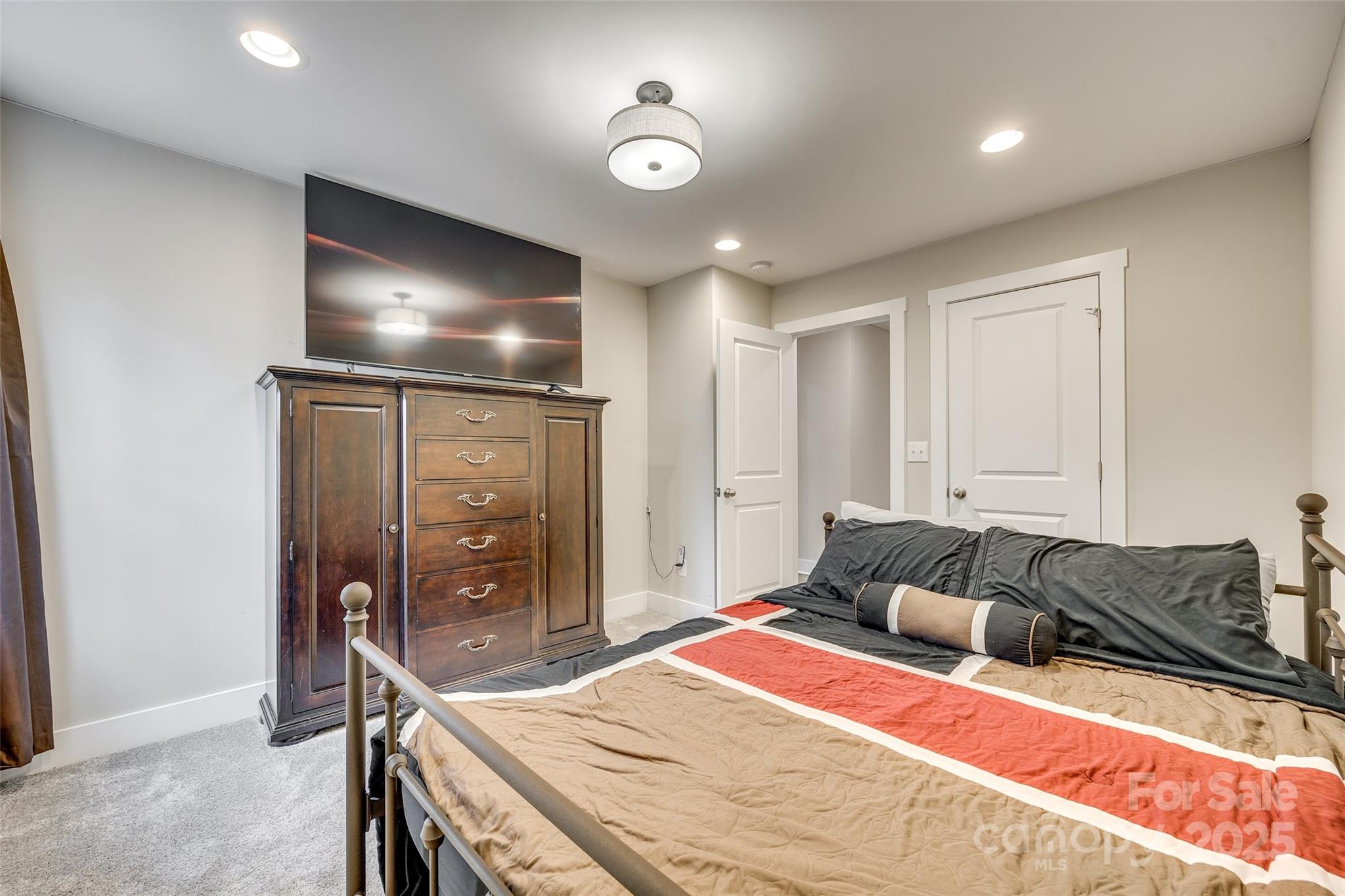 2024 Suttonview Road Fort Mill, SC 29708 - Photo 25 of 41 a bedroom with a bed and a flat tv screen on dresser