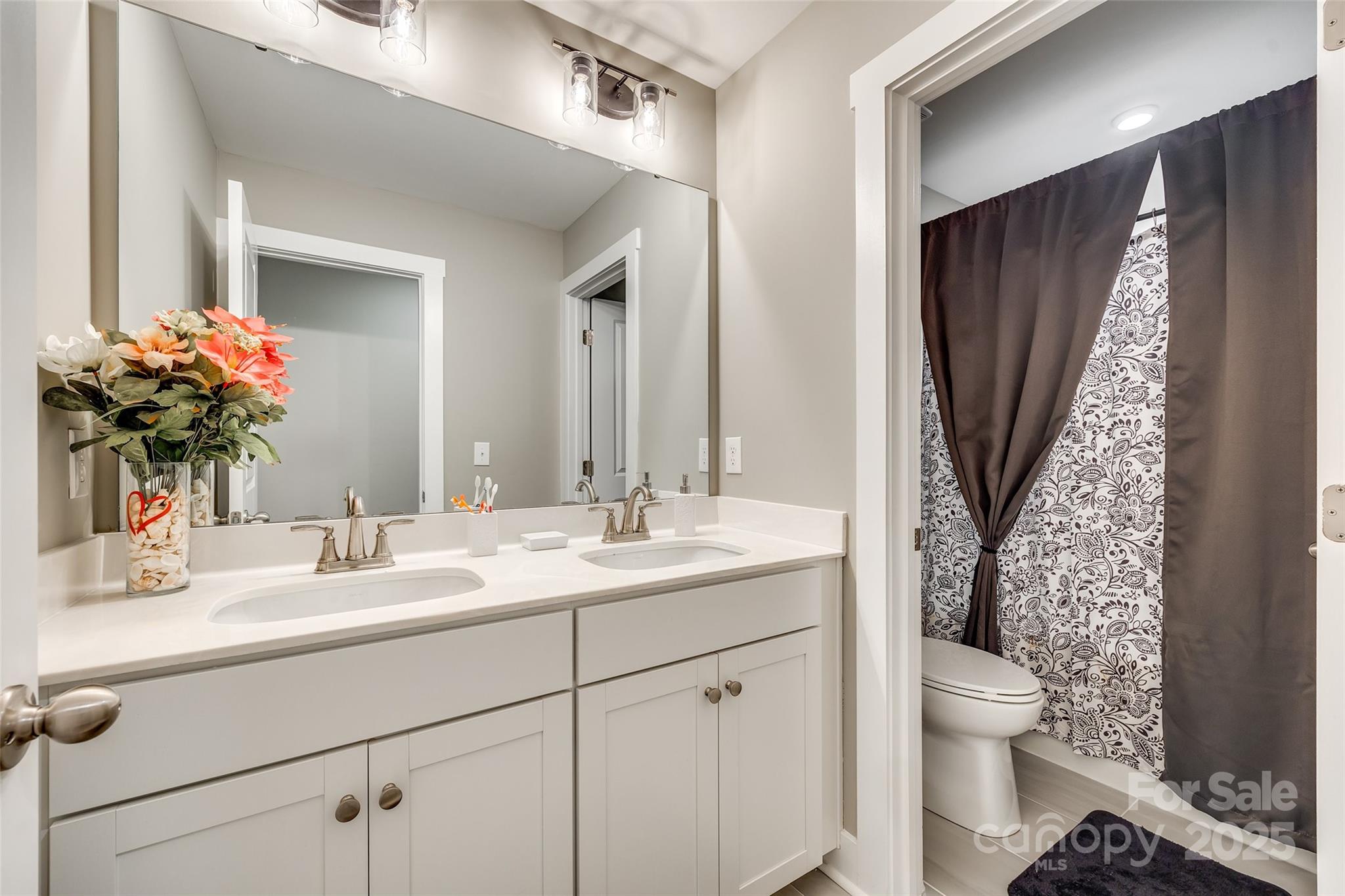 2024 Suttonview Road Fort Mill, SC 29708 - Photo 26 of 41 a bathroom with a granite countertop sink toilet and mirror