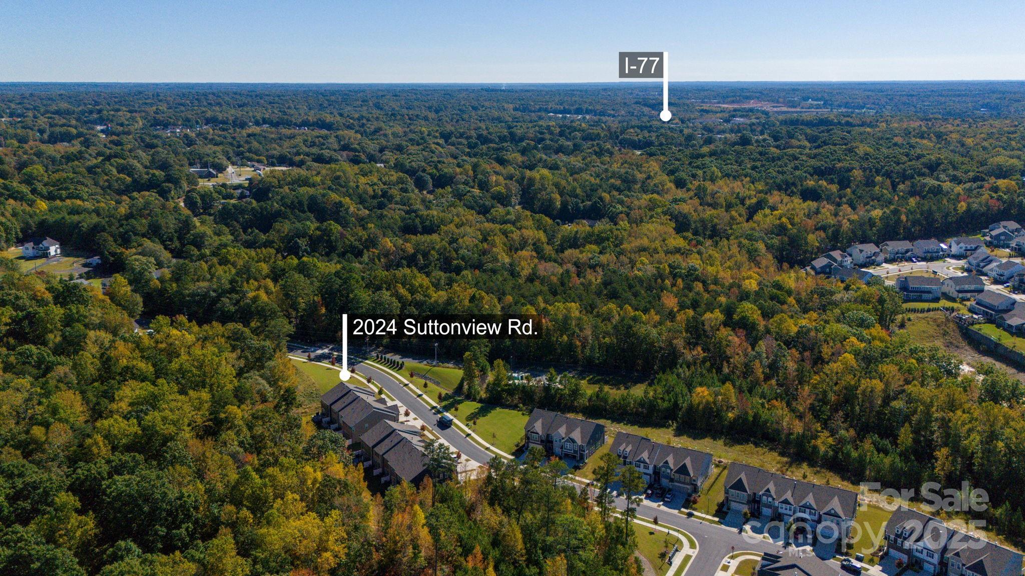 2024 Suttonview Road Fort Mill, SC 29708 - Photo 36 of 41 an aerial view of a city with lots of residential buildings ocean and mountain view in back