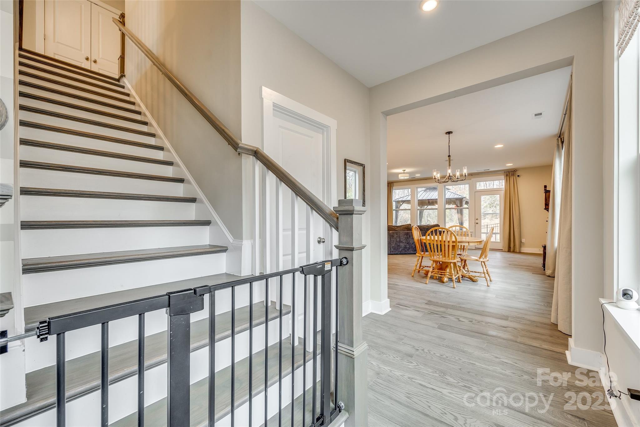 2024 Suttonview Road Fort Mill, SC 29708 - Photo 4 of 41 a view of staircase and dining room with wooden floor and a window