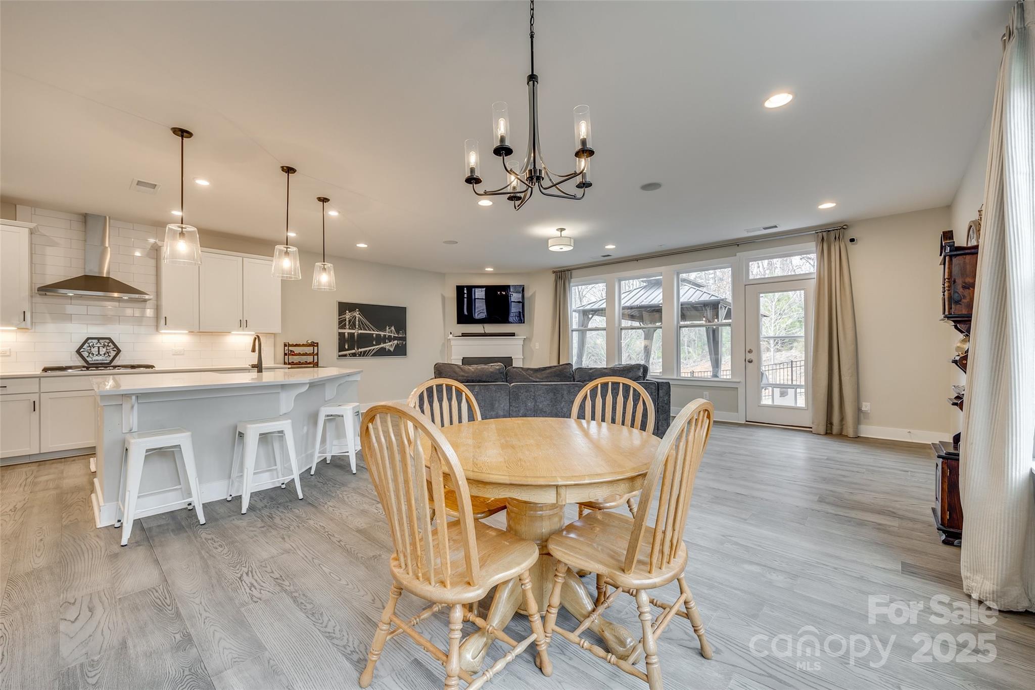2024 Suttonview Road Fort Mill, SC 29708 - Photo 5 of 41 a dining room with furniture a chandelier and kitchen view