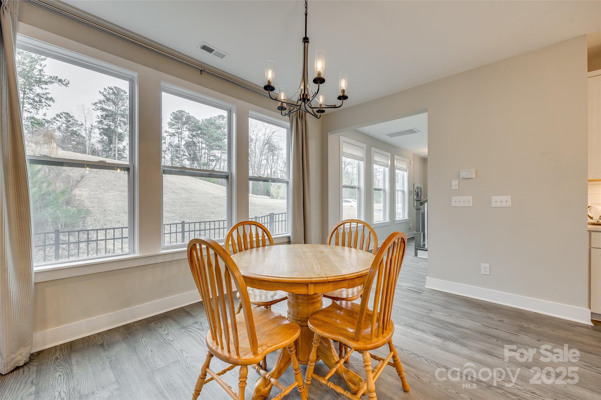 2024 Suttonview Road Fort Mill, SC 29708 - Photo 6 of 41 a dining room with furniture a chandelier and wooden floor