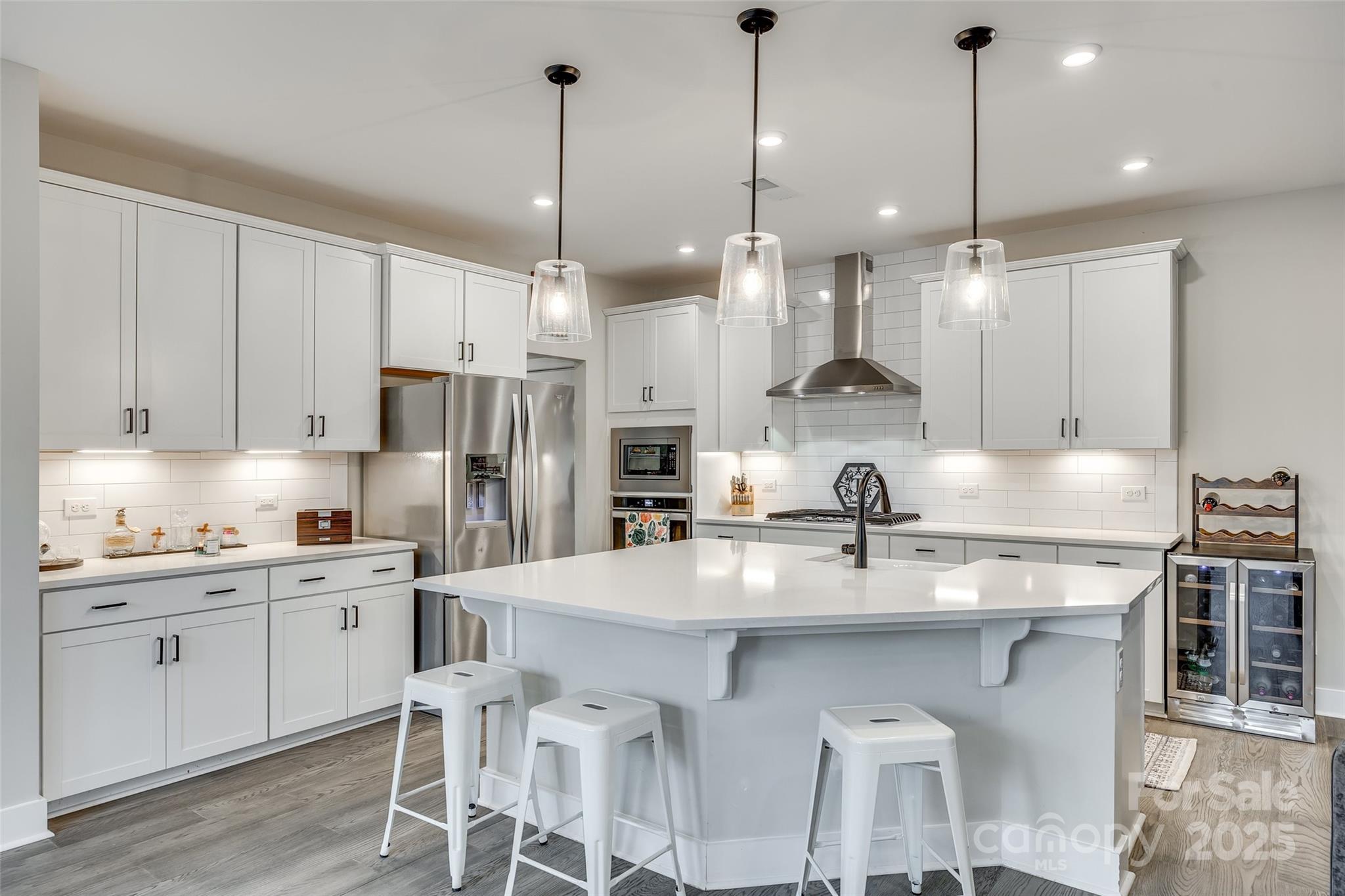 2024 Suttonview Road Fort Mill, SC 29708 - Photo 7 of 41 a kitchen with stainless steel appliances granite countertop a sink a stove a refrigerator and chairs